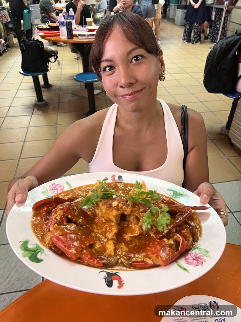 Woman holding a plate of chili crab