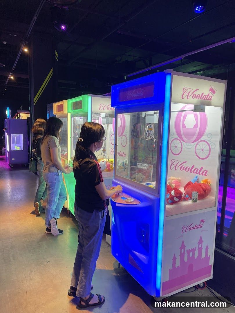 People playing claw machines