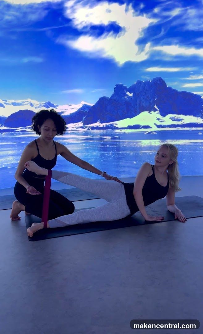 Yoga instructor assisting client