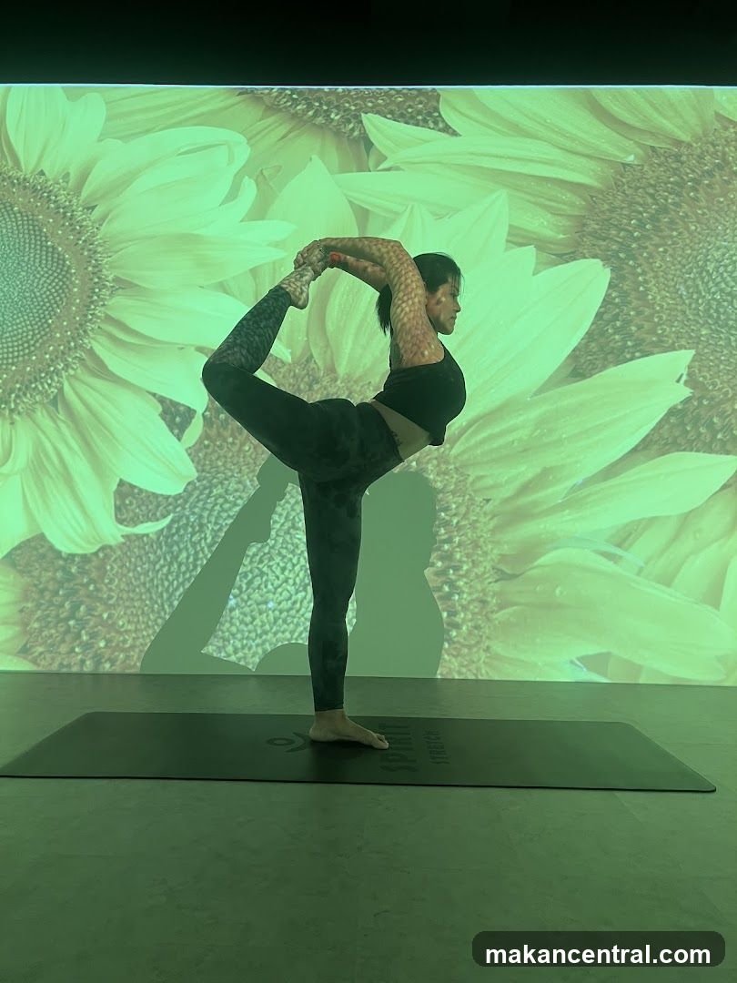 Woman practicing yoga in front of sunflower projection