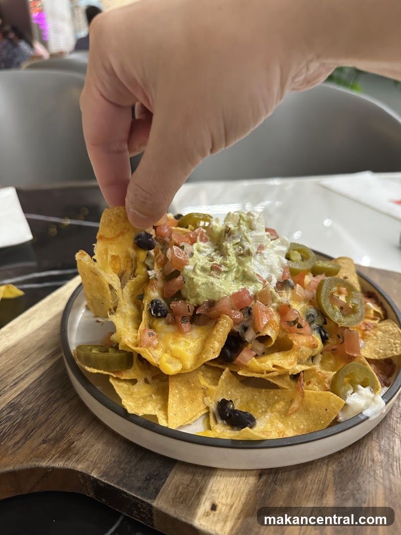 Hand reaching for nachos