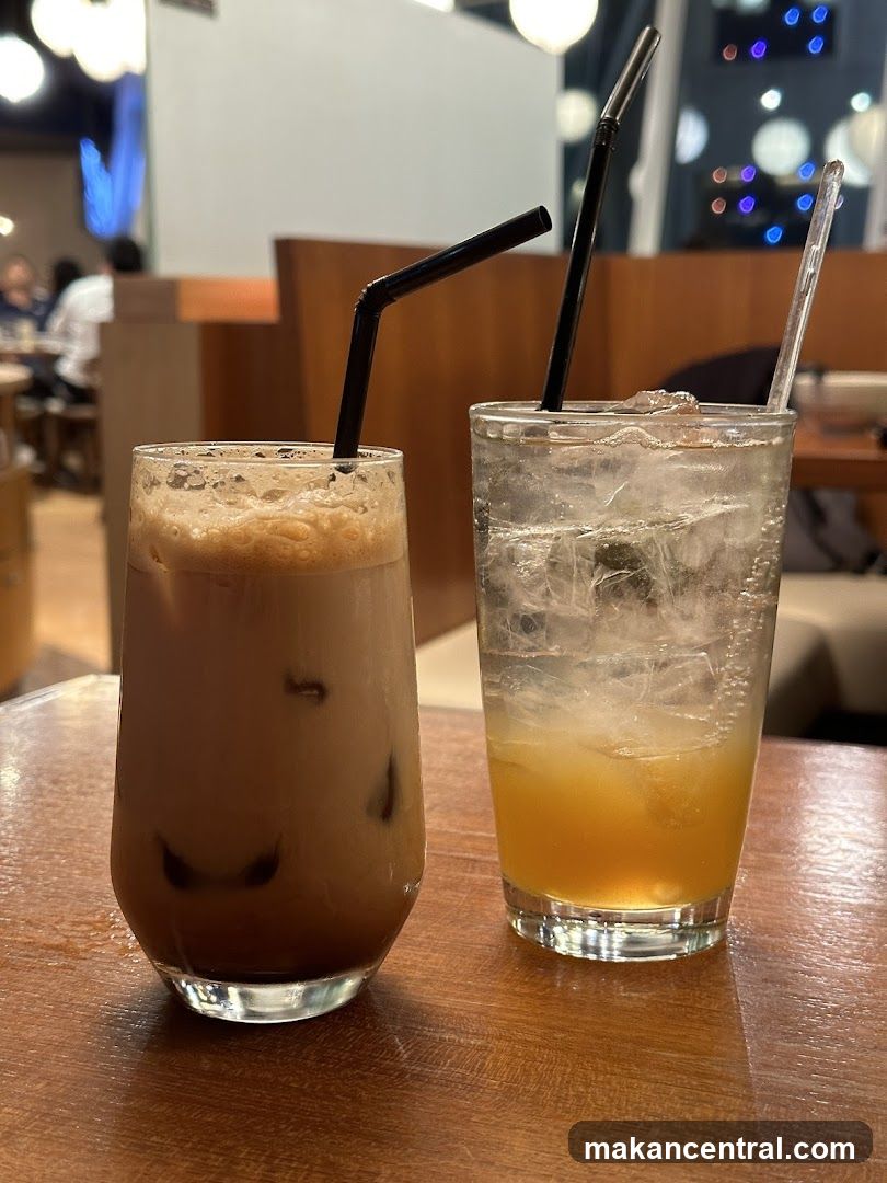 Two iced beverages on a wooden table