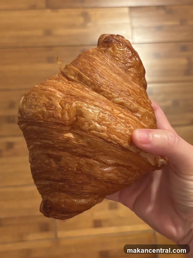 Hand Holding Croissant