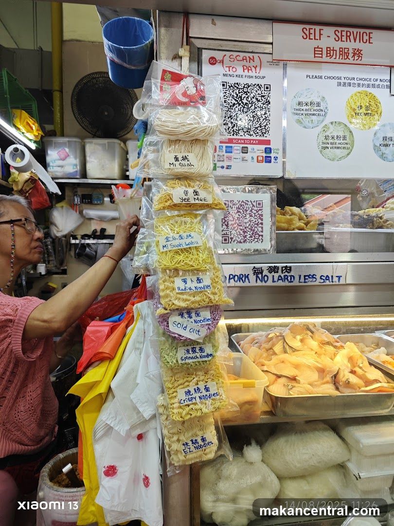 Food stall interior with noodle display and customer