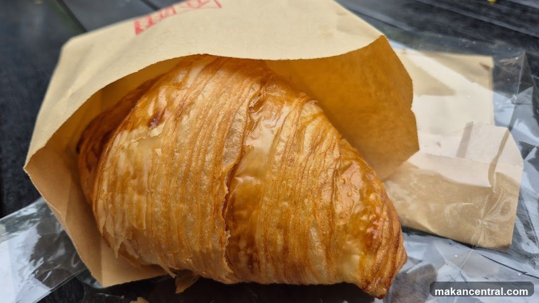 Croissant in paper bag