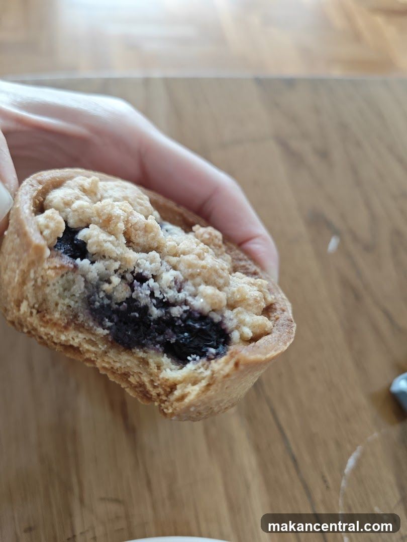 Hand holding a partially eaten pastry