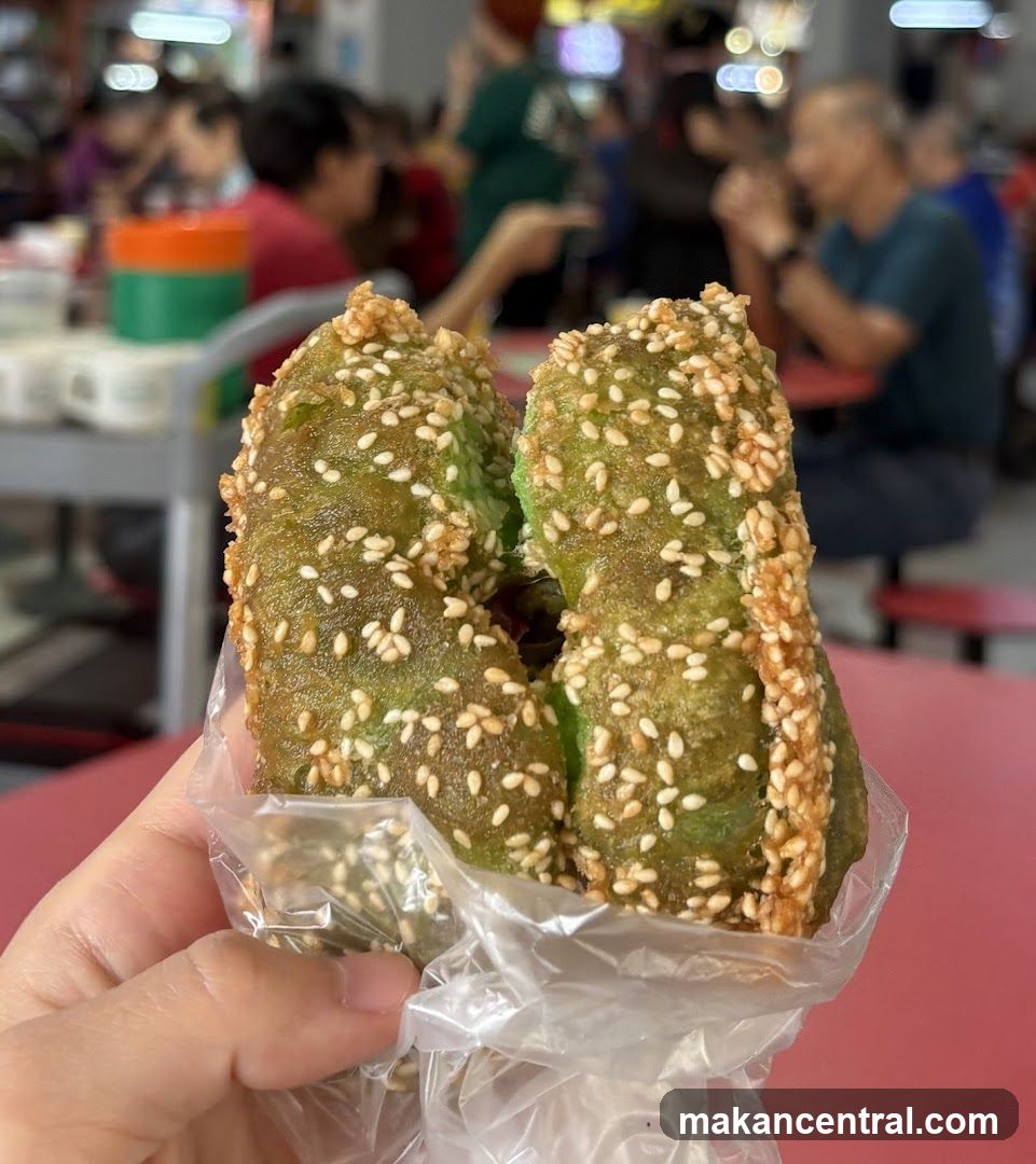 Hand holding green sesame snack