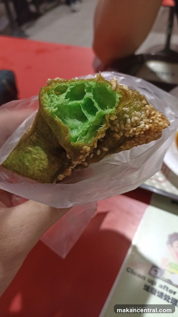 Hand holding green sesame snack