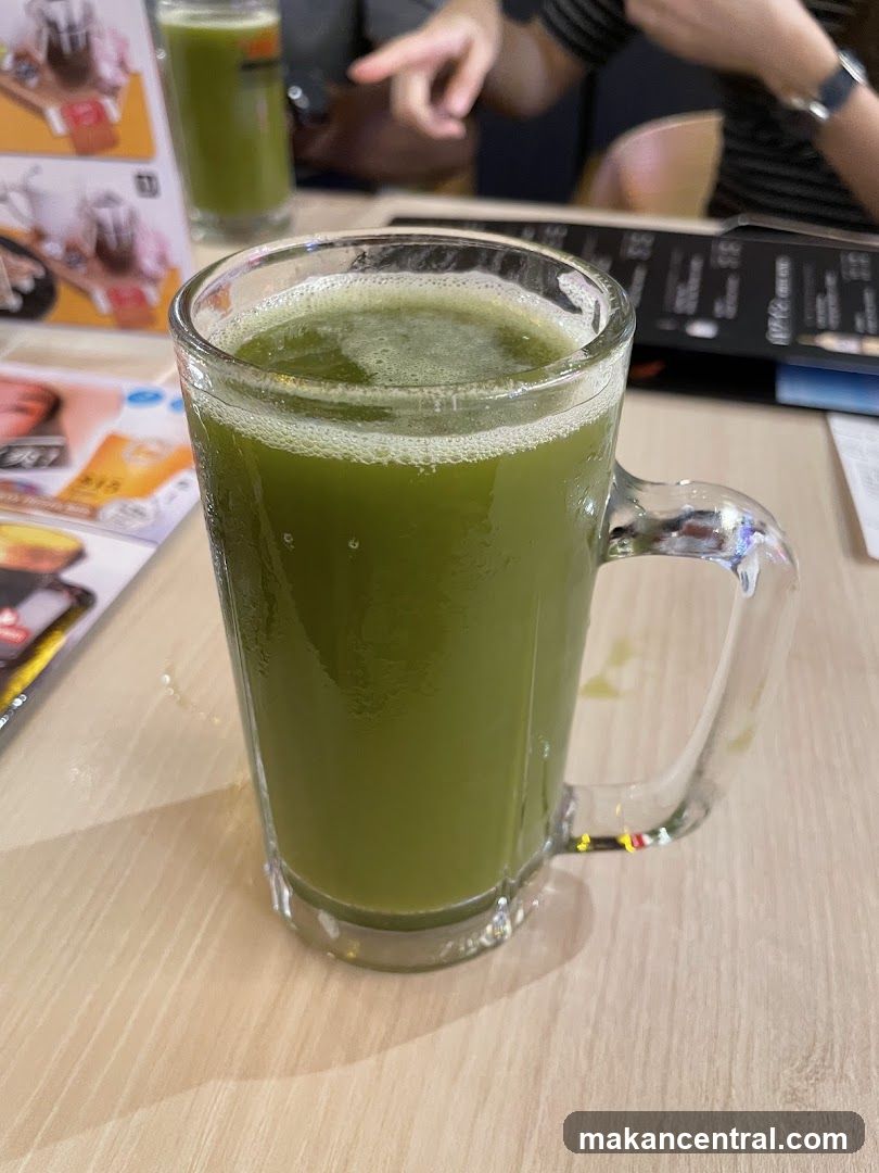 Green beverage in mug on table