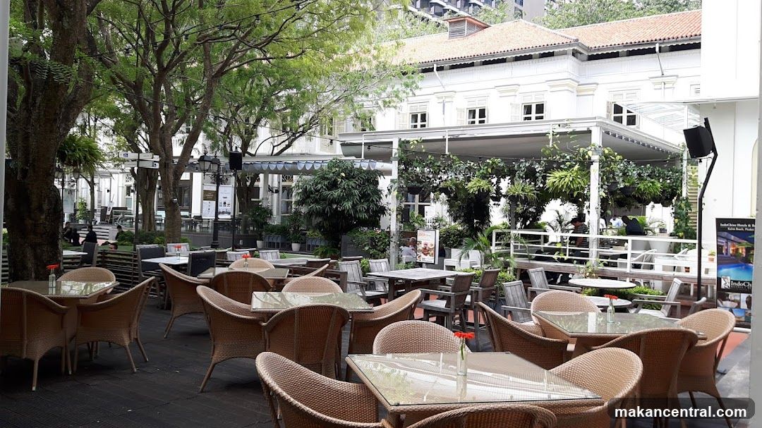 Outdoor seating area with trees and building facade