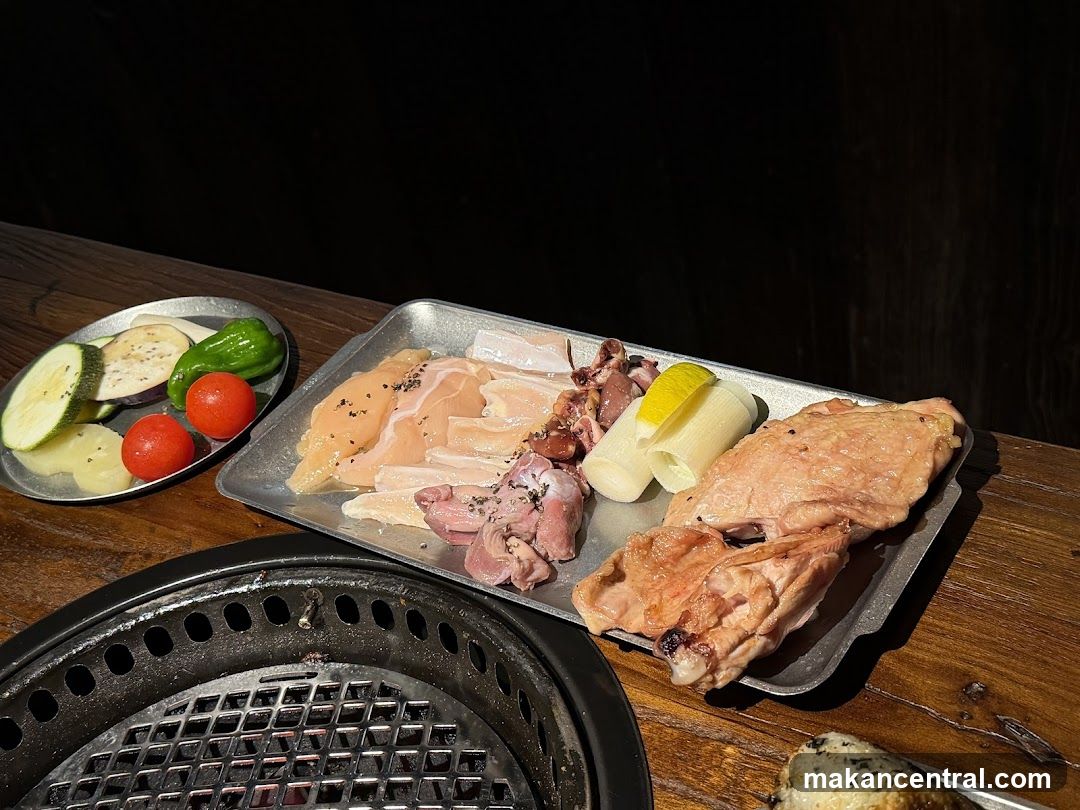 Grilled meat and vegetables on a wooden table