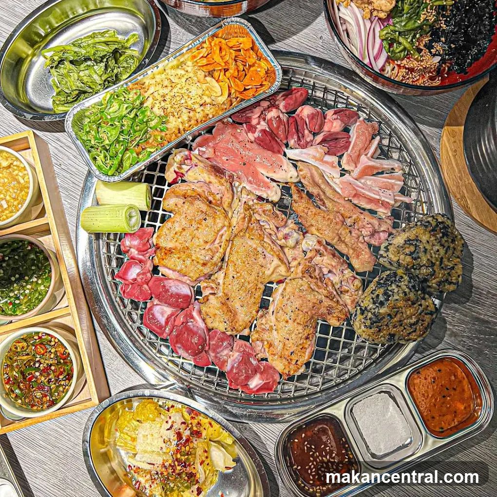 Grilled meat and side dishes spread on a table