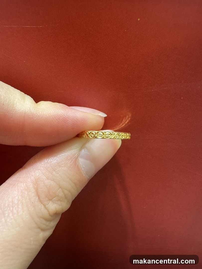 Hand Holding Gold Ring