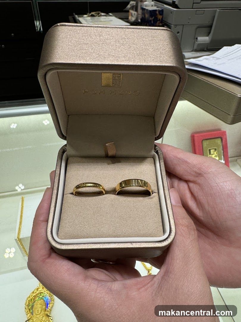Hand holding gold ring box