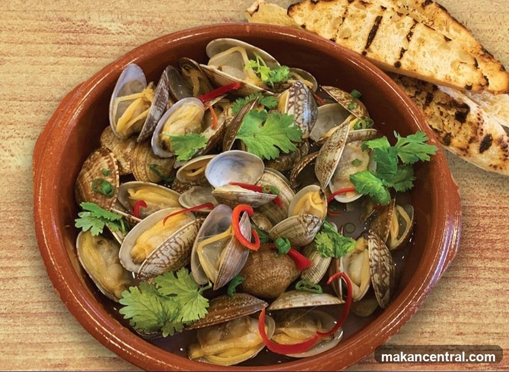 Clams with herbs and red chili in a terracotta bowl