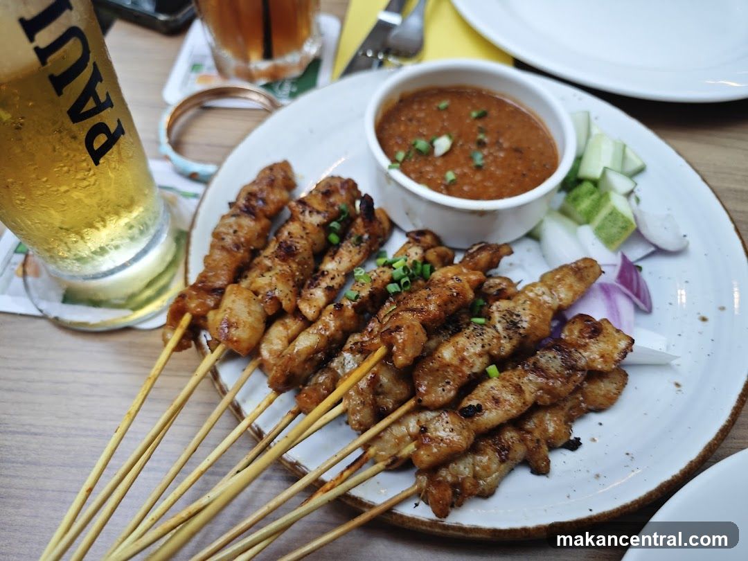 Grilled skewers with dipping sauce and drink