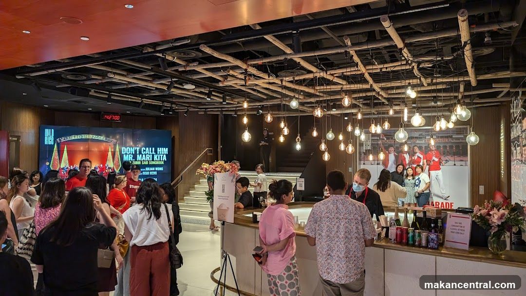 Interior of a venue with crowd and bar area