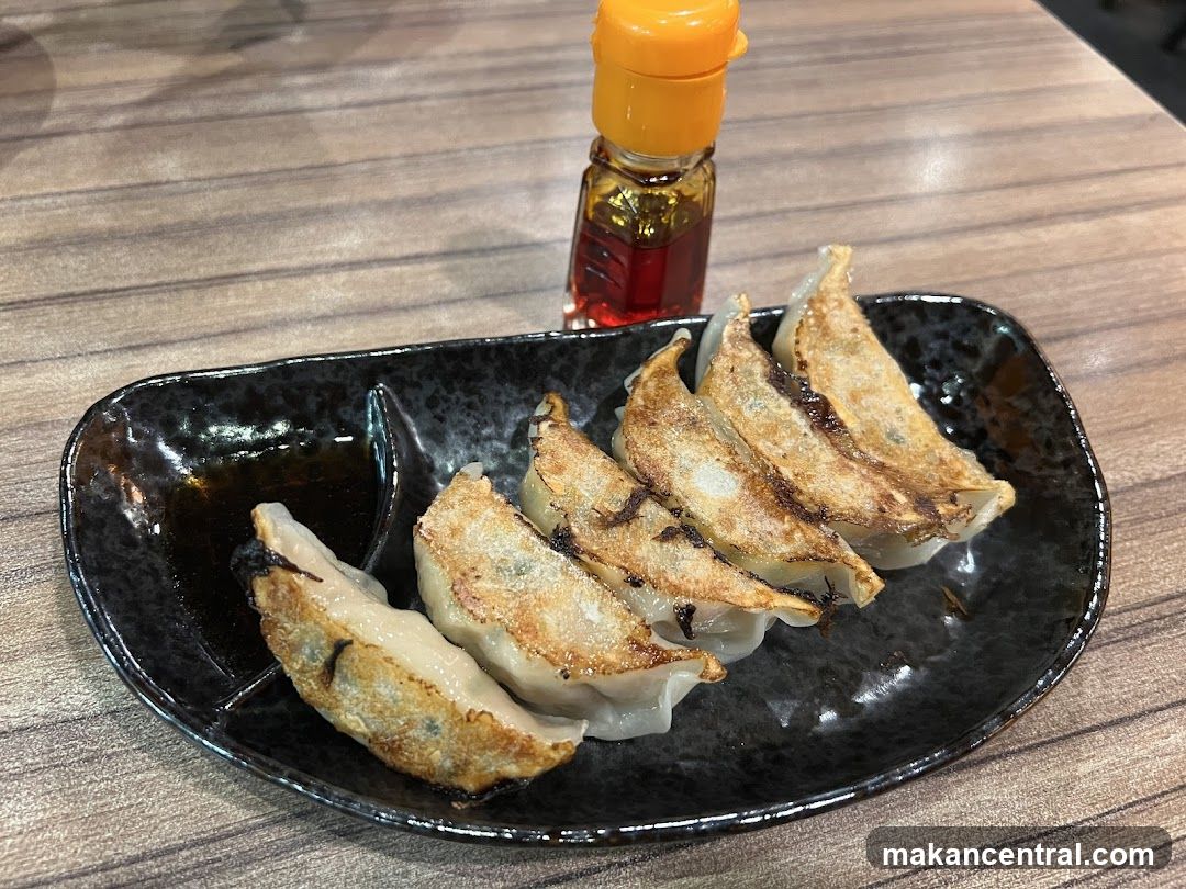 Gyoza on Plate with Sauce Bottle