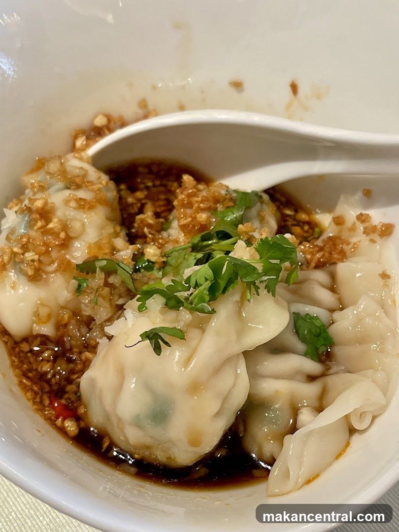 Dumplings in bowl with sauce and garnish