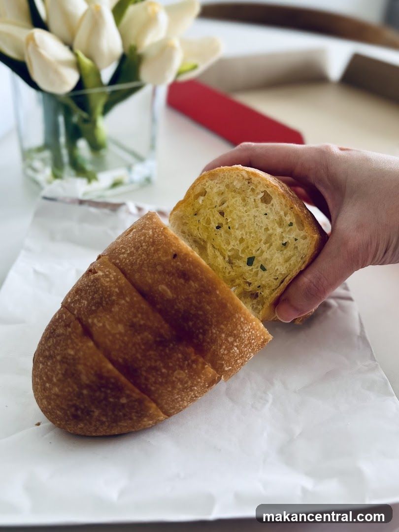 Hand Holding Garlic Bread