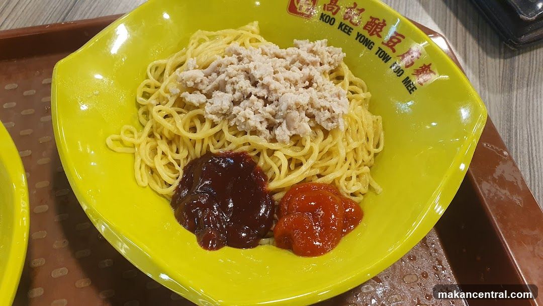 Noodles with toppings on a yellow plate