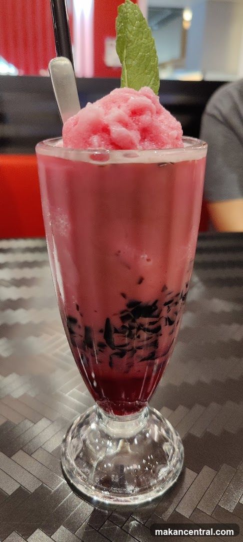 Pink beverage with mint garnish