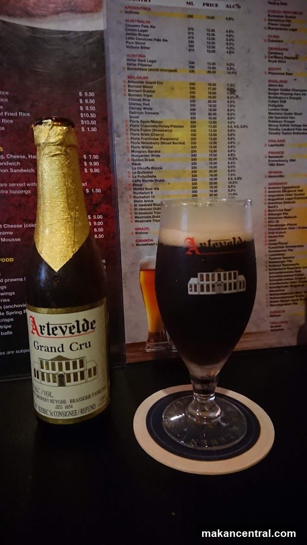 Beer and glass on counter with menu in background