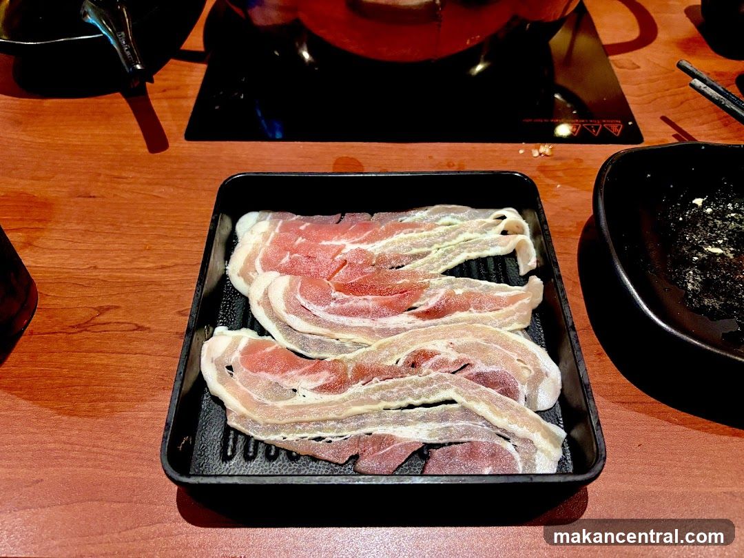 Grilled meat on a tray at a dining table