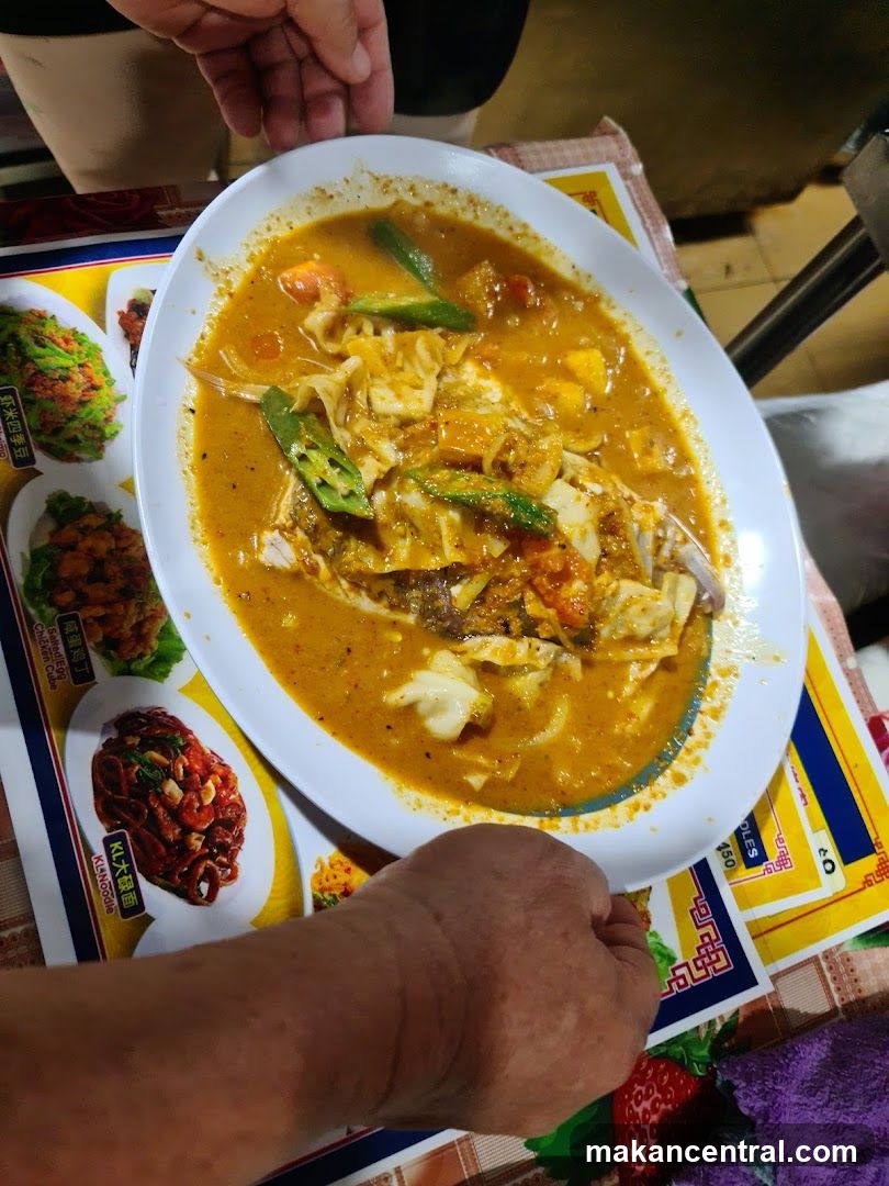 Food dish on table with hands