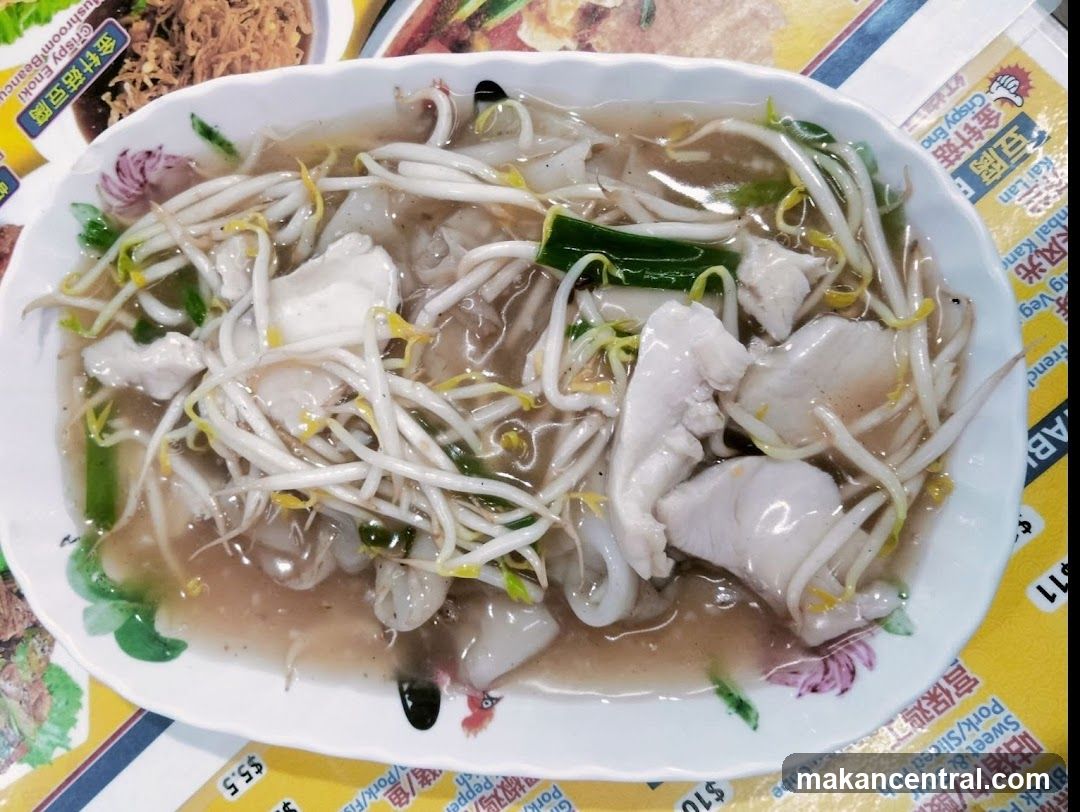 Food dish on table with printed materials