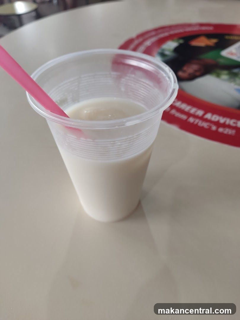 Milk in plastic cup with pink straw