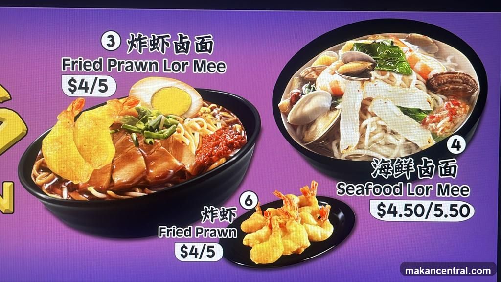 Digital menu board displaying three lor mee dishes with prices in USD. Includes Fried Prawn Lor Mee, Seafood Lor Mee, and individual fried prawn side dish.