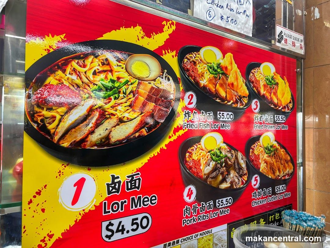 A brightly colored red and yellow menu board displaying five Lor Mee dishes with prices in USD. The main dish is labeled '1' as 'Lor Mee $4.50', followed by four other options: Fried Fish Lor Mee ($5.00), Fried Prawn Lor Mee ($5.50), Pork Ribs Lor Mee ($5.50), and Chicken Cutlet Lor Mee ($5.00). All items are shown with images of the bowls, including toppings like boiled eggs, meat slices, and greens.