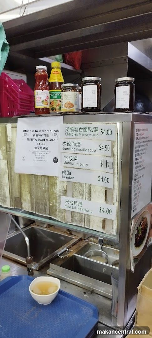 Food stall interior with sauce bottles and price list