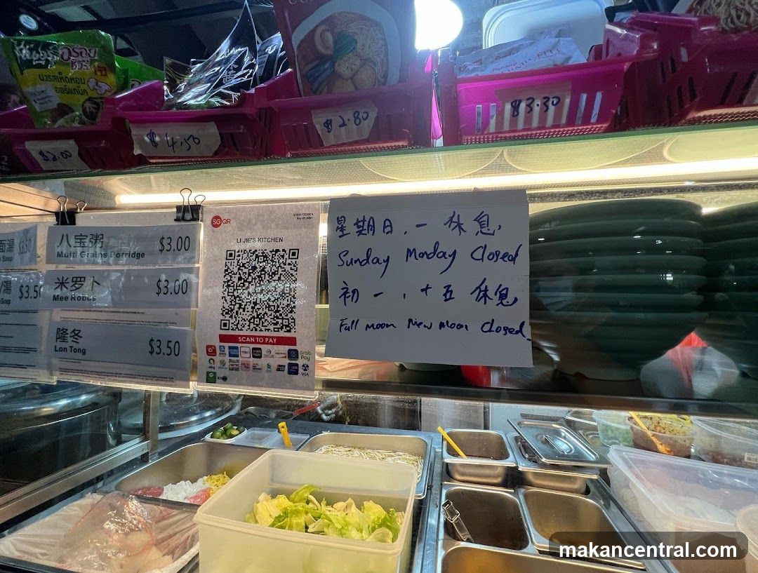 Food stall interior with pricing and closure notice