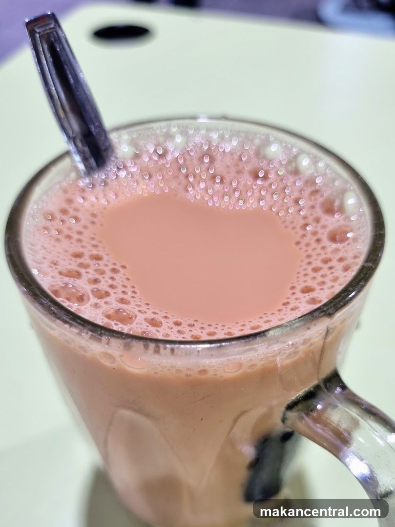 Milk tea in glass mug with spoon