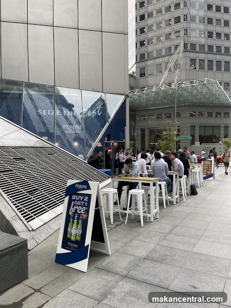 Outdoor seating area with Peroni advertisement