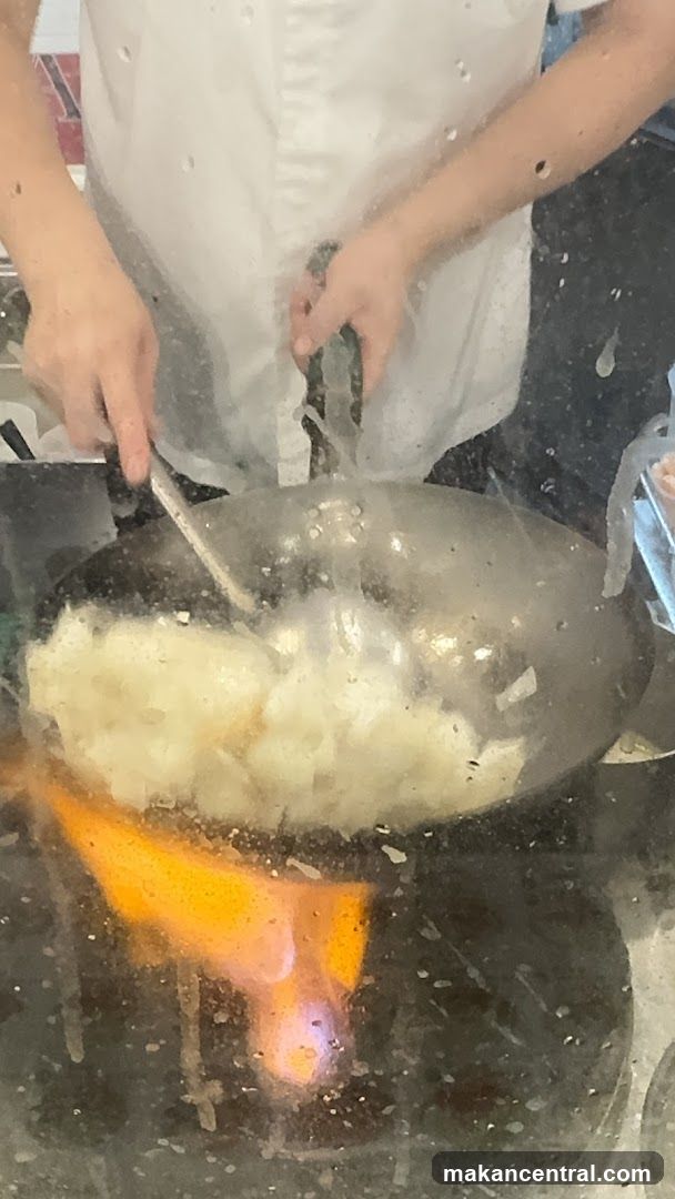 Cooking in wok over open flame