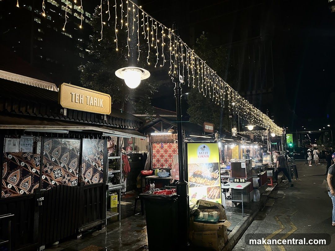 Nighttime street food stalls with festive lighting