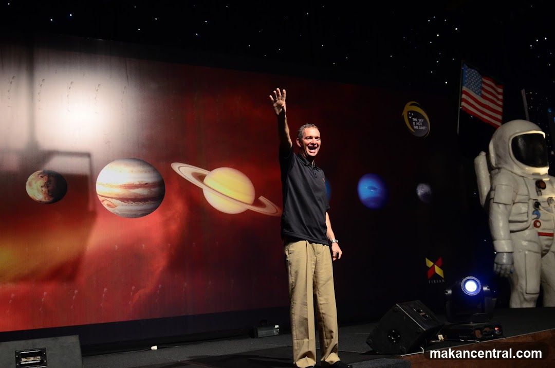Speaker on Stage at Space-Themed Event