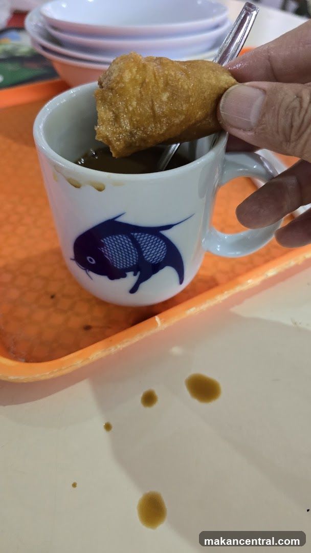 Hand dipping food in cup