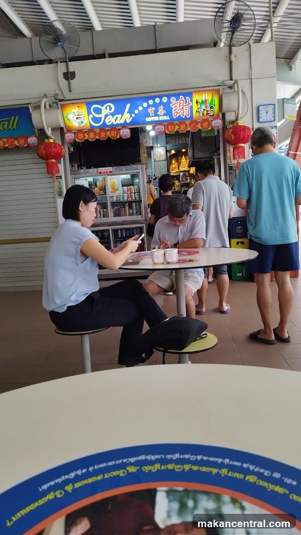 People at a food stall in an open-air market