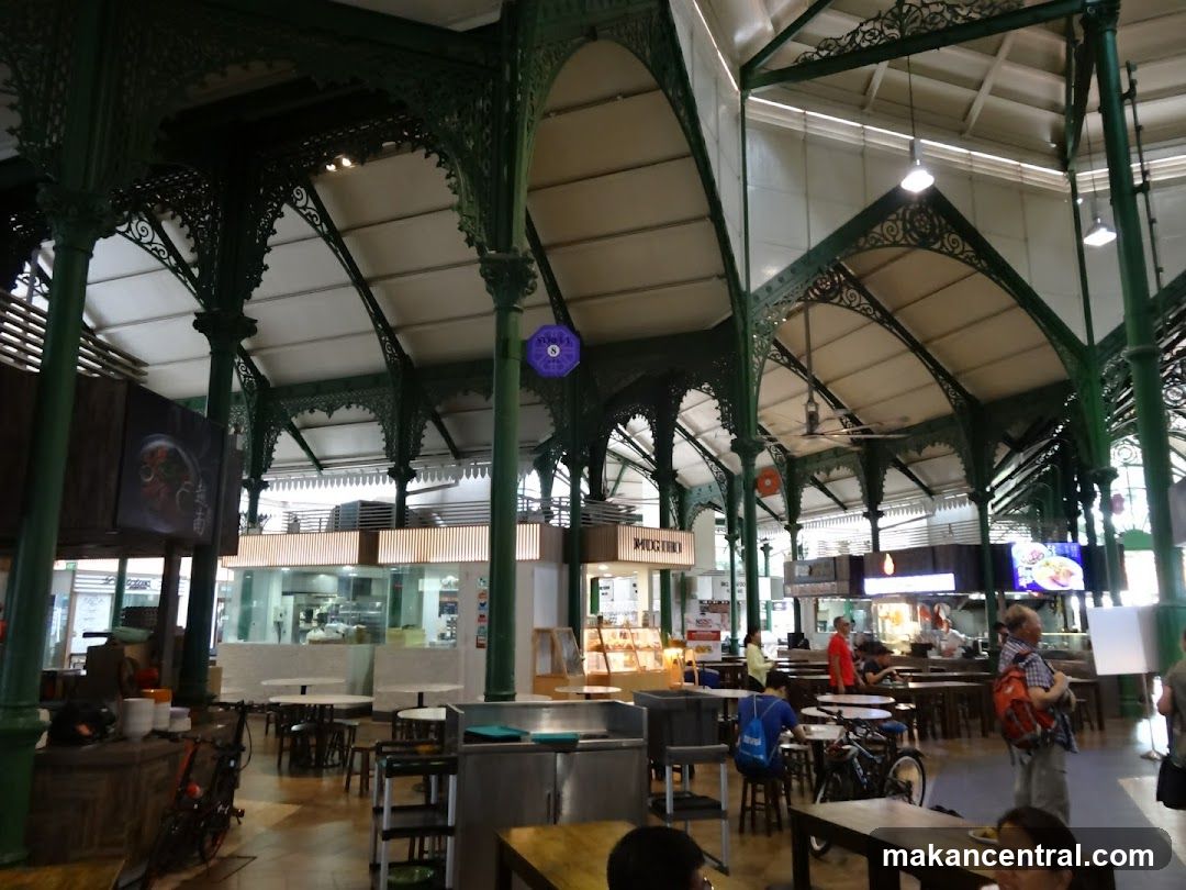 Interior of a food court with green metal framework