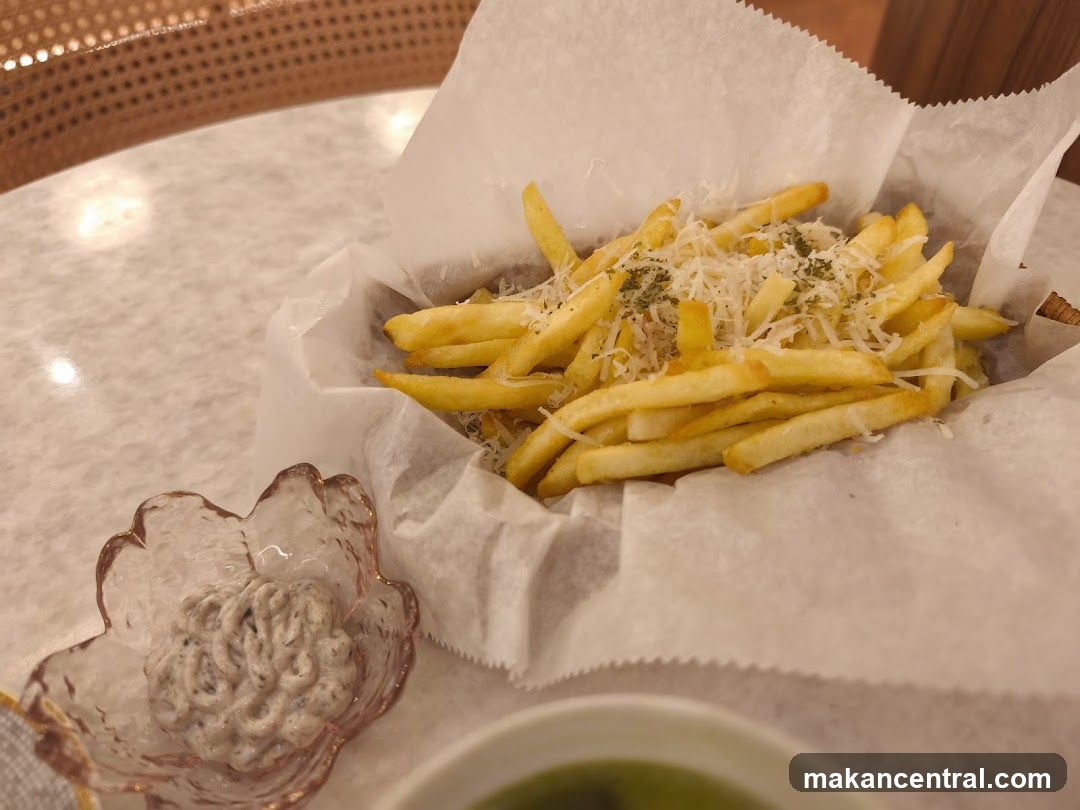 Fries with garnish and dipping sauce