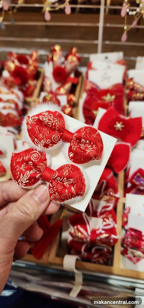 Hand holding red decorative bows