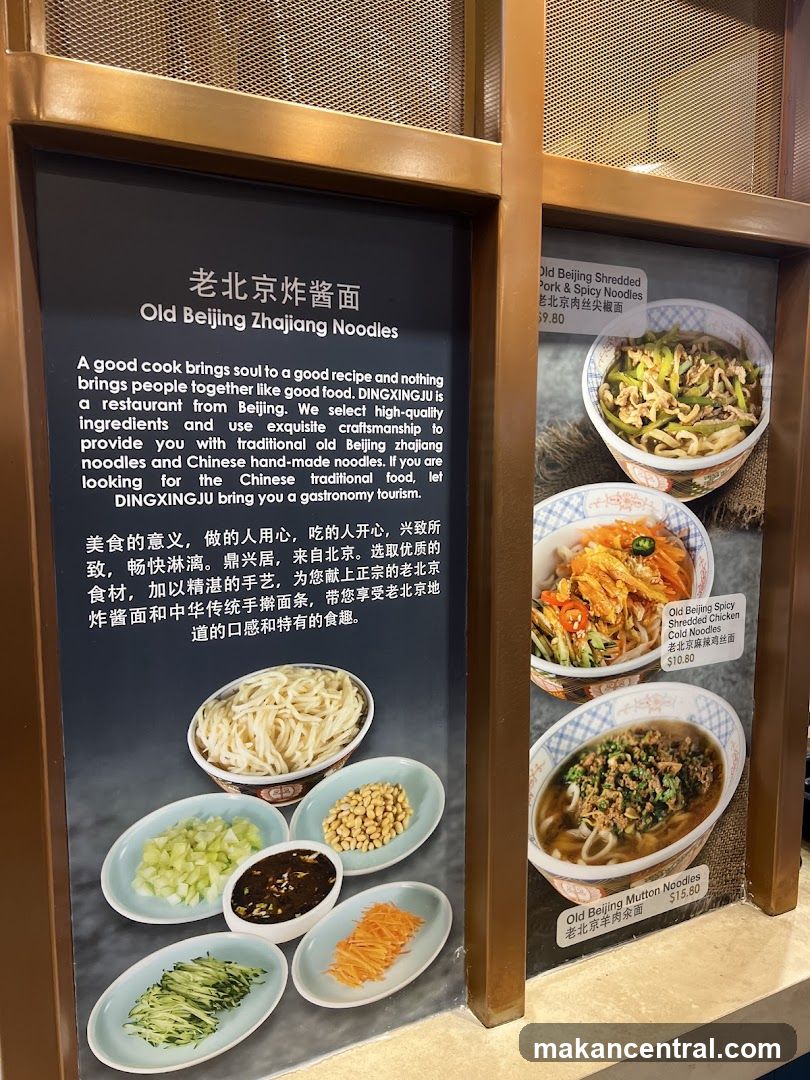 Menu board featuring Old Beijing Zha Jiang Noodles with images of dishes and ingredients. Displays three noodle varieties: Shredded Pork & Spicy Noodles ($9.80), Spicy Shredded Chicken Cold Noodles ($10.80), and Mutton Noodles ($15.80). Includes descriptive text in English and Chinese about the restaurant’s philosophy.