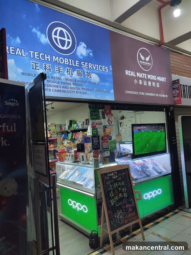 Storefront with blue and maroon signage showing business names in English and Chinese. Green illuminated 'oppo' branding on display cases. A television inside shows a soccer match. A chalkboard sign stands outside with handwritten promotions in Chinese. The shop appears to be a mobile phone service and convenience store, with shelves stocked with products and various promotional stickers on the glass window.