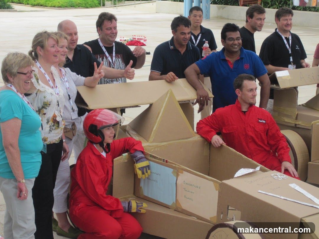 Group with cardboard vehicle