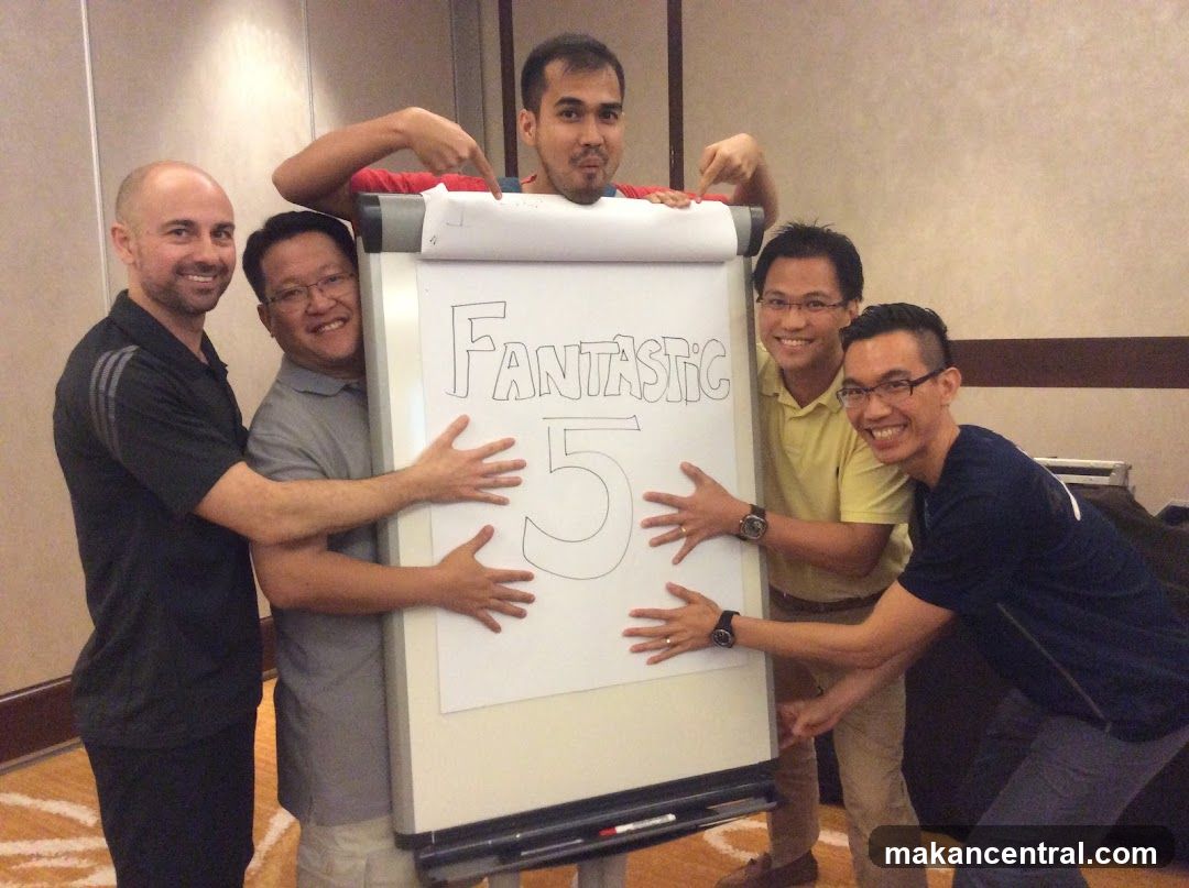 Group posing with whiteboard