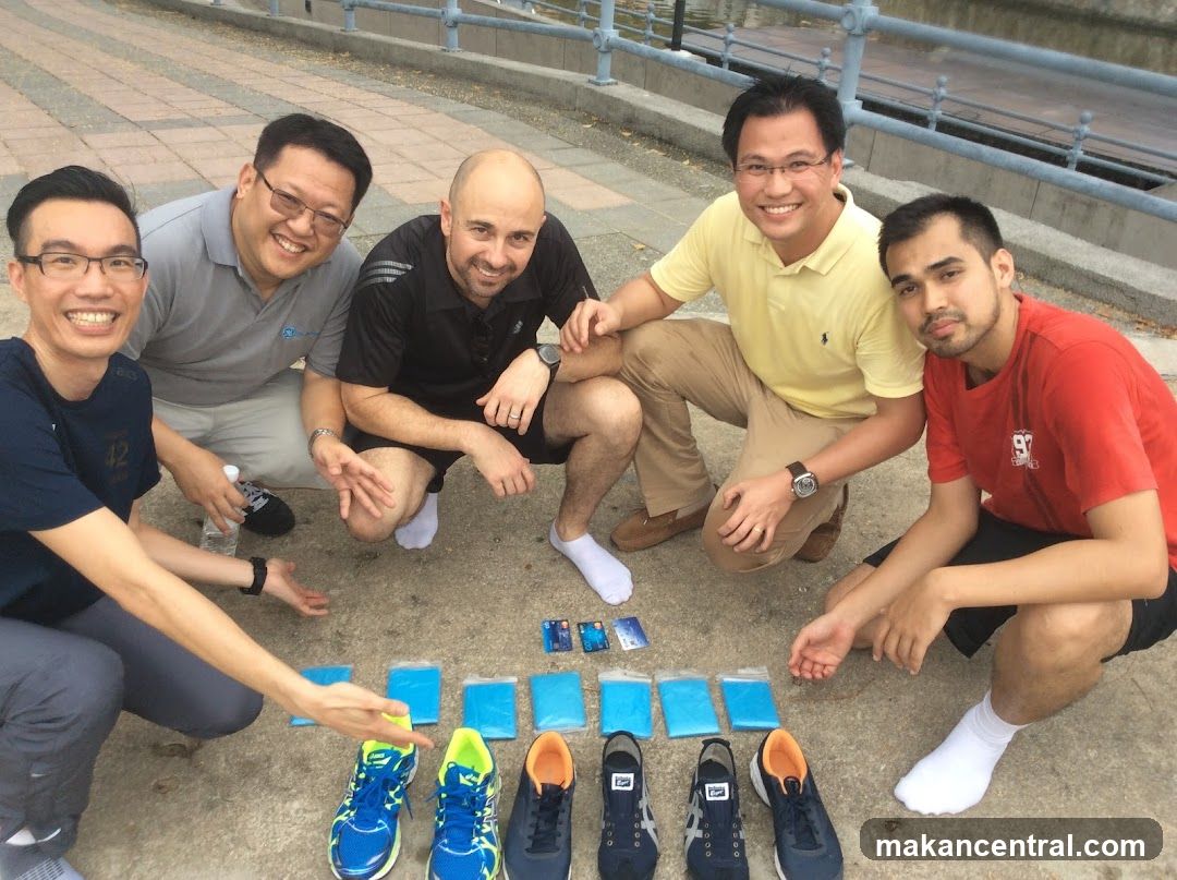 Group of men posing with shoes and cards